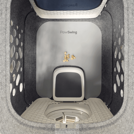 Top view of PawSwing AutoComb Pro inside a clean, spacious grooming area with anti-slip mat and feeding treats.