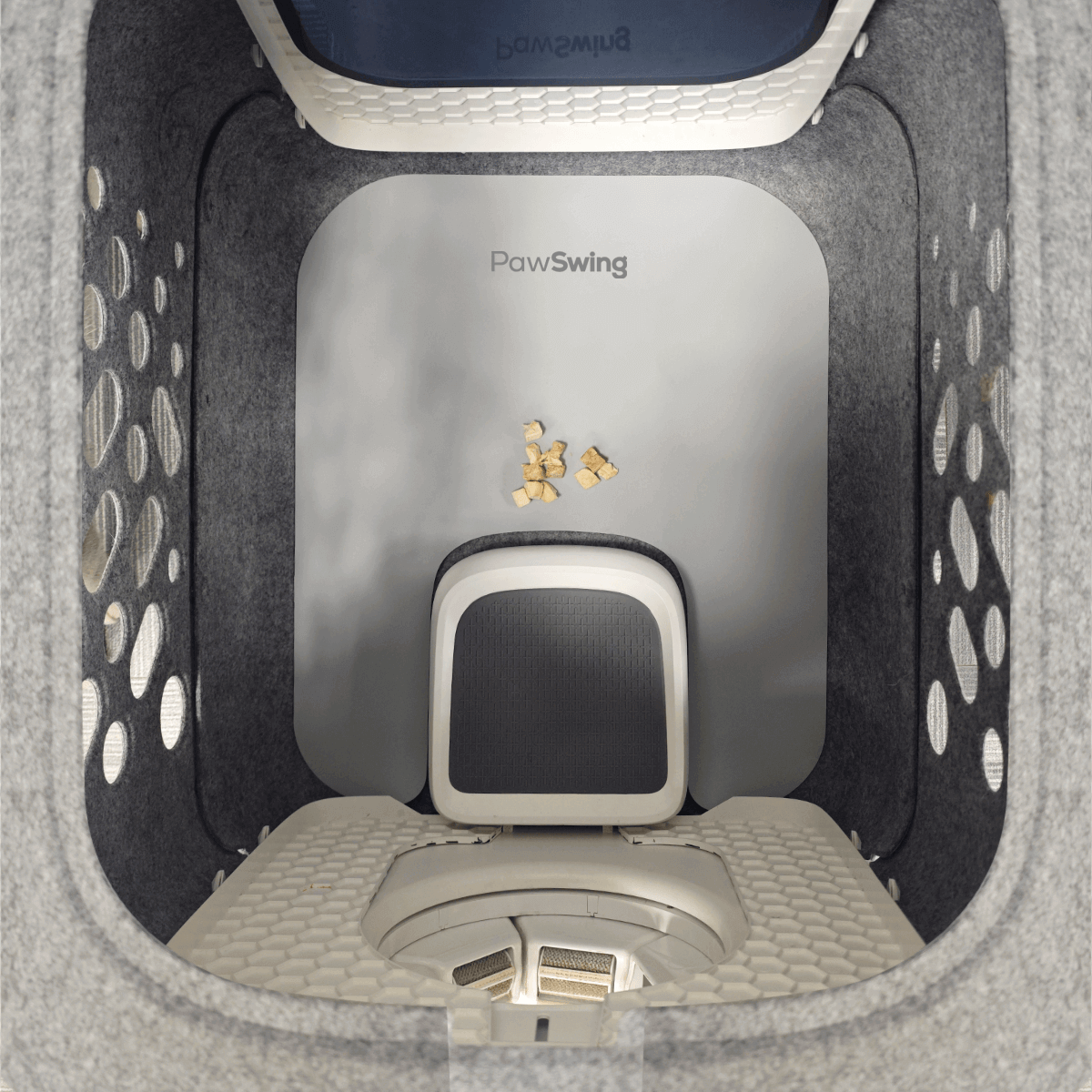 Top view of PawSwing AutoComb Pro inside a clean, spacious grooming area with anti-slip mat and feeding treats.