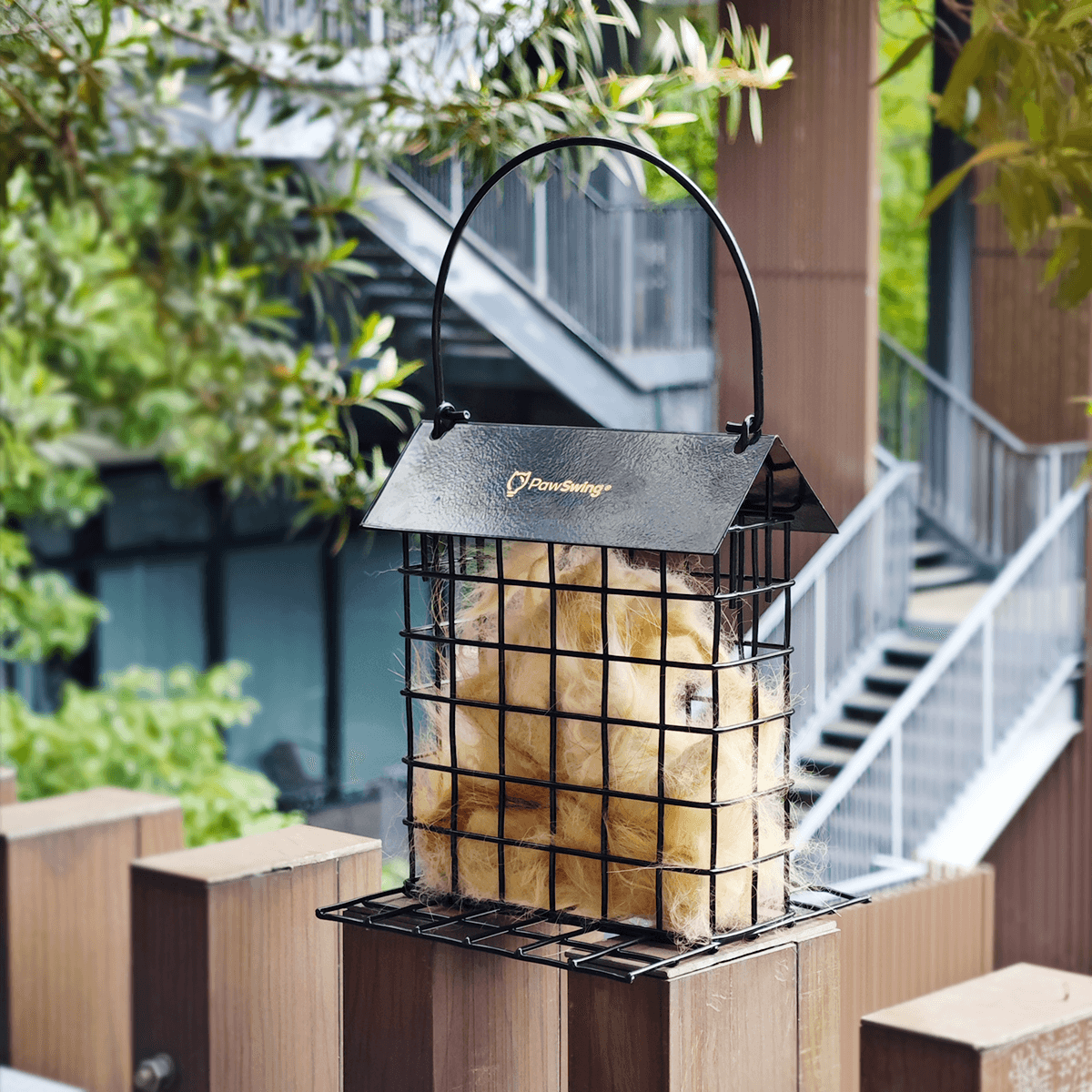 Eco-friendly PawSwing Cat Hair Suet Collector hanging outdoors, filled with cat fur, providing nesting material for birds.