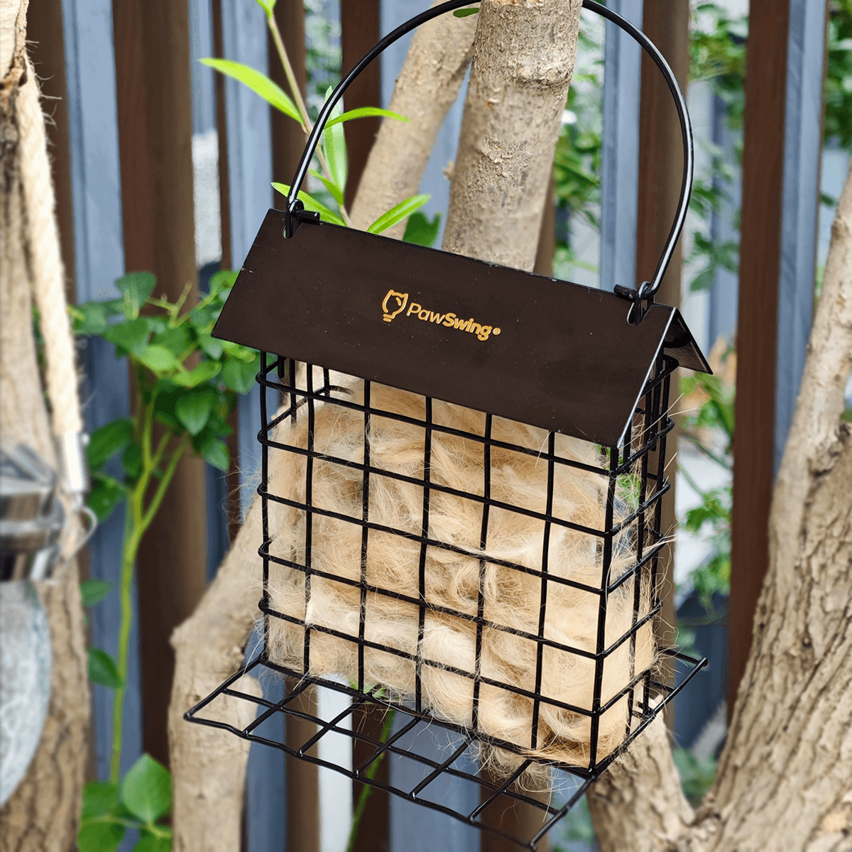 PawSwing Cat Hair Suet Collector filled with cat fur, designed for bird nesting, hanging on a tree.